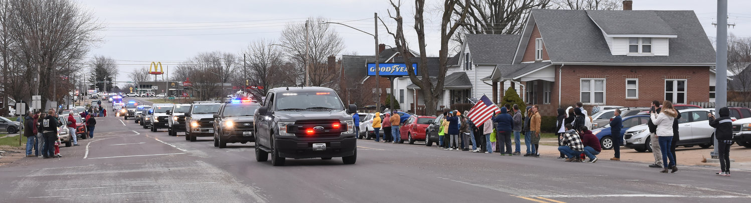 Owensville Residents line Highway 28 as  the body of Hermann Det. Sgt. Mason Griffith drive into town in a 27-vehicle procession.
