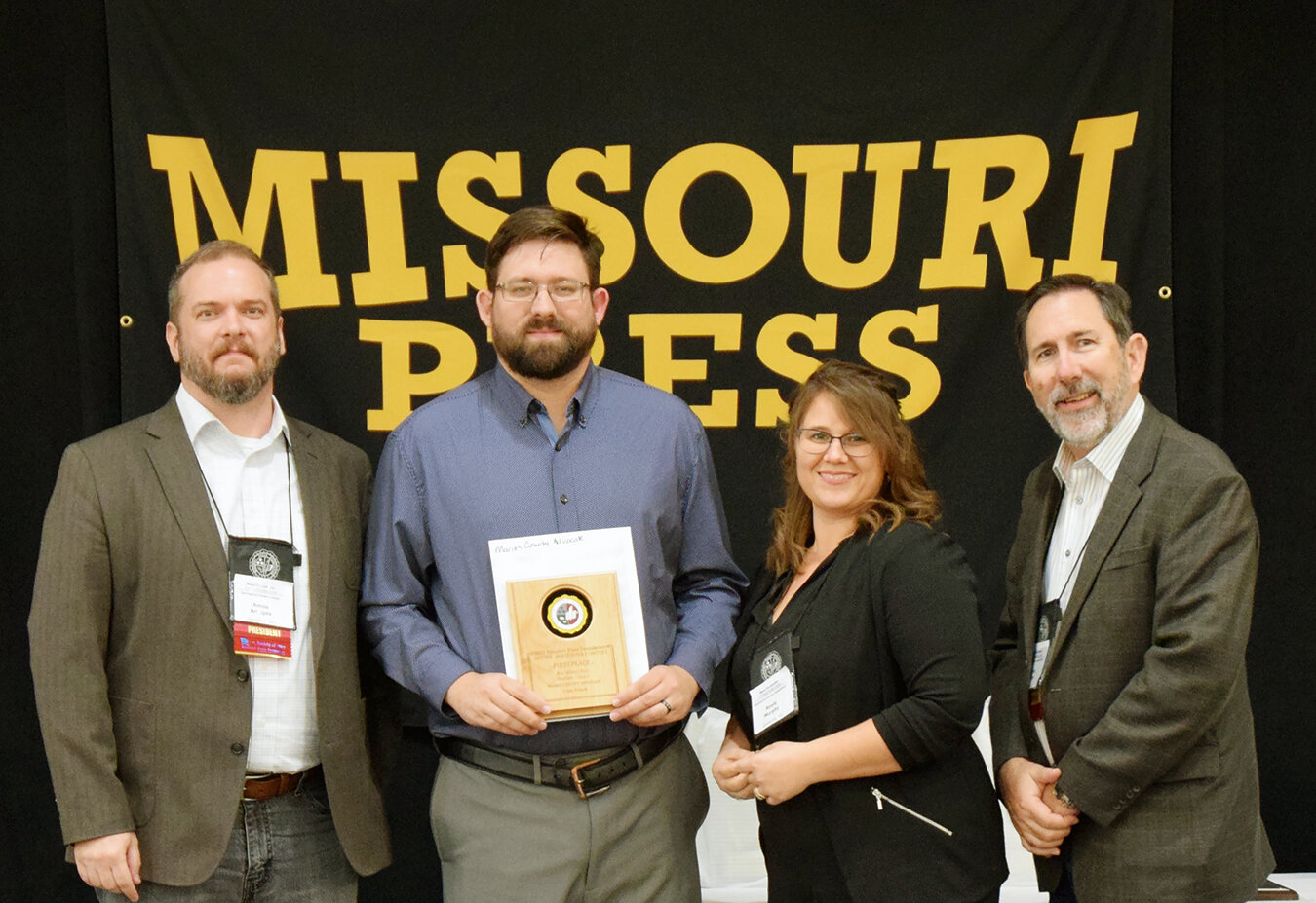 Maries County Advocate management and staff Jacob Warden, Roxie Murphy and Dennis Warden accept Missouri Press Association awards Saturday in St. Louis from Amos Bridges, incoming president.