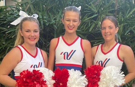 Kaitlyn Campbell, Claudia Wieberg and Eva Hollis in their cheer uniforms.