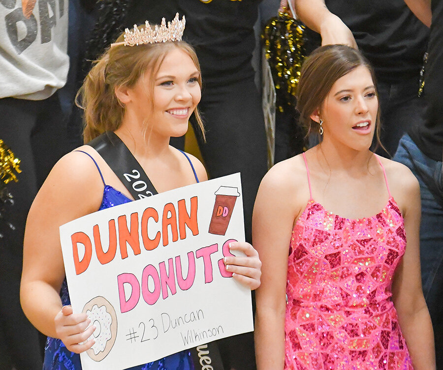 Homecoming Queen Kara Bastion (left) is pictured alongside homecoming candidate Jaelee Stricklan cheer on the Eagles during the game.